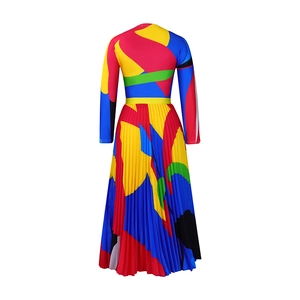 Detail of colorful abstract print and pleated texture on the long-sleeve dress fabric
