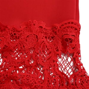 Detail of red floral lace embroidery and mesh fabric on a stylish evening dress