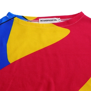 Detail of waffle knit fabric and vibrant geometric color block pattern on a collar