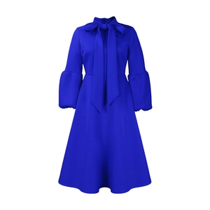 Detail of royal blue midi dress featuring high neck bow tie and puff sleeves