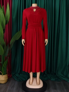 Detail of red elegant high neck dress showing beaded neckline and ruched waistline design