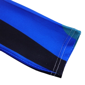 Detail of blue and black honeycomb mesh fabric with precise white double-row stitching