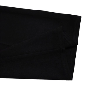Detail shot of black knitted fabric sleeve with high-quality flat seam stitching