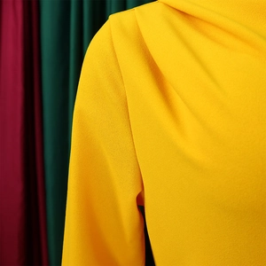 Detail of elegant bright yellow pleated dress shoulder with textured chiffon fabric