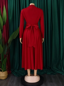 Detail of red high-neck dress showing elegant shoulder beadings and waist bow tie back