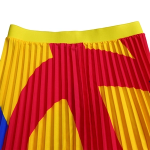 Detailed view of the yellow elastic waistband and blue star print pleated skirt fabric