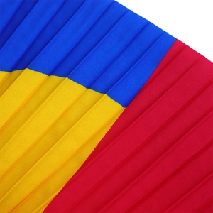 Detail of multi-color pleated fabric with bold blue, yellow and red geometric patterns