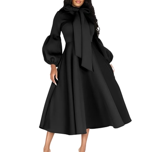 Detail of elegant black dress with oversized bow tie neck and vintage lantern sleeves