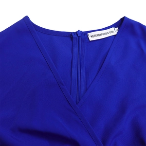 Detail of royal blue V-neck dress with neat stitching and METAMORPHOSIS GIRL brand label