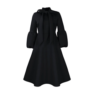 Detail of elegant black dress with bow tie neckline and stylish puff lantern sleeves
