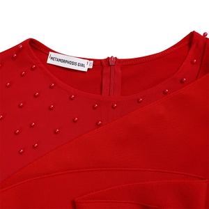 Detail of red mesh patchwork jumpsuits with decorative beads and hidden back zipper
