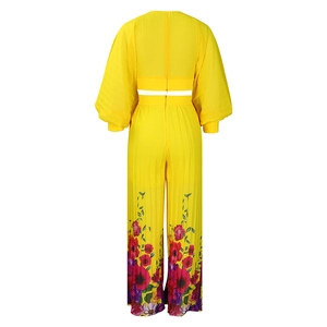 Detail of yellow pleated long sleeve top and wide leg pants with floral print on back view