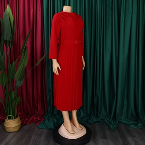 Detail of red pleated maxi dress with elegant waist belt and long sleeves for formal wear