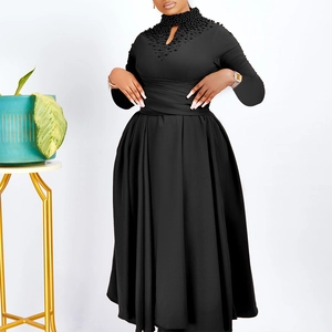 Detail of beaded water-drop neckline and cinched waist on this elegant black dress