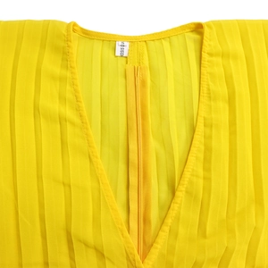 Detail of V-neckline on bright yellow pleated top with back zipper and size label