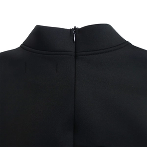 Detail shot of a black puff sleeve dress showing the stand collar and back hidden zipper