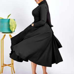 Detail of high neck black dress with beaded embellishments and long sleeves