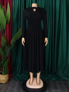 Detail of high neck black dress with pearl beading and teardrop cutout design