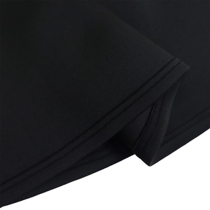 Detailed close-up of double-needle stitching on the hem of a black evening gown dress