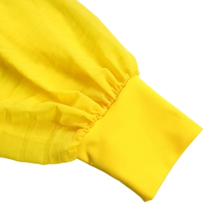 Detail of yellow pleated chiffon sleeve showing fine fabric texture and elastic cuff