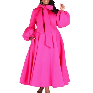 Detail of rose pink dress with puff sleeves and oversized bow neckline design