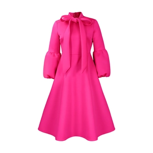 Close-up of elegant rose pink midi dress with bow tie neck and puff lantern sleeves
