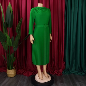 Detailed view of long sleeve pleated green dress with an elegant waist belt