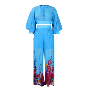 Detail of light blue V-neck chiffon jumpsuit with tropical floral print and wide waist belt