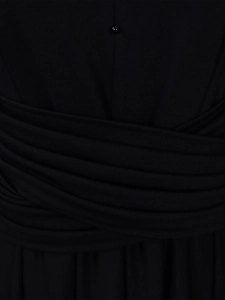 Close-up of the elegant draped waist and decorative bead detail on the black dress