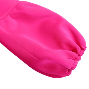 Detailed macro view of the hot pink lantern sleeve with elastic shirred cuff texture