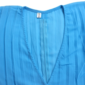 Detail of V-neck pleated top in light blue with interior brand label and size tag S