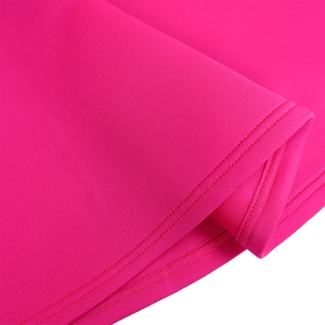 Close-up of double stitching and high-quality fabric texture on rose pink dress hem