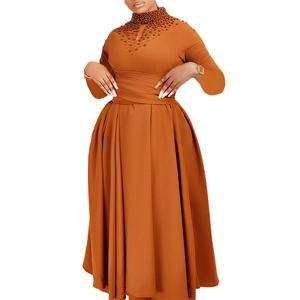 Close-up of caramel brown dress with high neck beadwork and waist-cinching detail