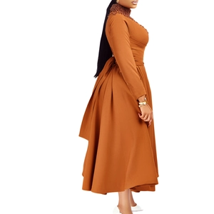 Detail showing high-neck beaded decoration and waist pleats on caramel maxi dress