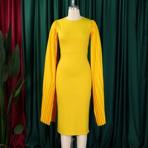 Macro detail of vibrant yellow pleated cape sleeves on a slim party evening dress