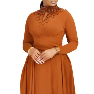 Detail of high neck with pearls and teardrop cutout on orange maxi dress