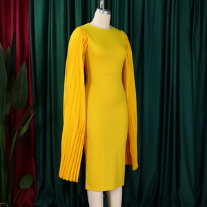 Detailed view of elegant yellow bodycon dress featuring dramatic pleated long sleeves