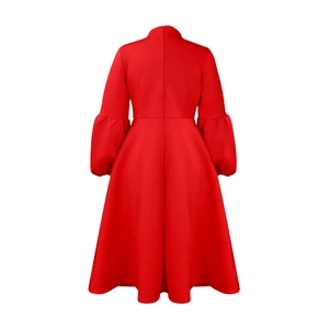 Detail view of the back of a red high-neck evening gown with puff sleeves and invisible zipper
