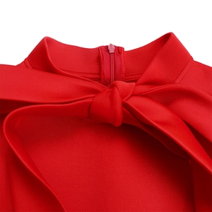 Detail of red plus size dress featuring high collar and large decorative bow tie