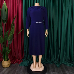 Detailed view of dark blue pleated dress with matching belted waist and round neckline