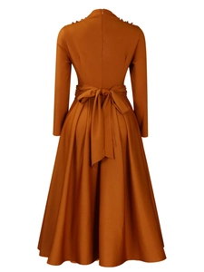 Back view of caramel high-neck midi dress with shoulder beadwork and waist bow tie