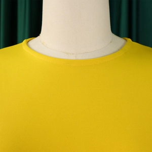 Close-up of vibrant yellow knitted round neckline with precise double-needle stitching detail