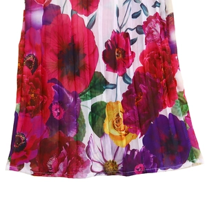 Detail of vibrant floral print on lightweight pleated chiffon fabric with clean stitching