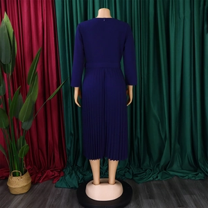 Detail of the pleated hem and back zipper of a deep purple long-sleeved dress