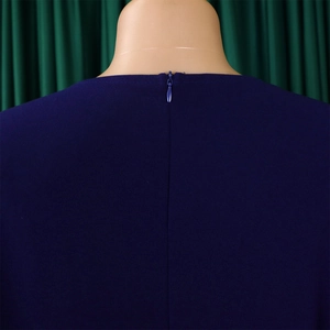 Macro detail of dark blue dress showing high-quality invisible zipper and smooth fabric texture