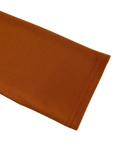 Macro detail of ribbed caramel knit fabric and high-quality double-needle stitching