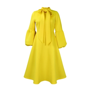 Detail of lemon yellow puff sleeve dress with a decorative bow neckline and belted waist