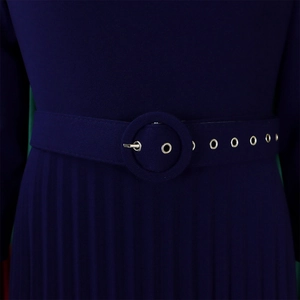 Detail of dark blue pleated dress featuring a round buckle belt with silver eyelets
