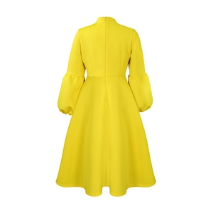 Detail of high-waist yellow puff sleeve dress with a back invisible zipper closure