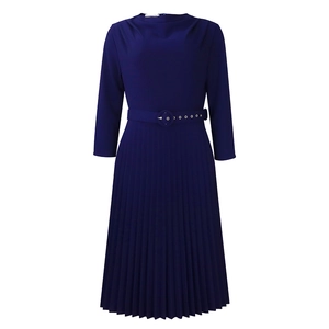 Detail of the navy blue pleated dress featuring a belted waist and accordion skirt texture